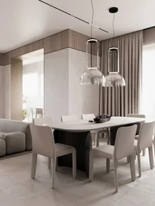 Modern minimalist dining room with a marble table, glass pendant lights, and fabric chairs.