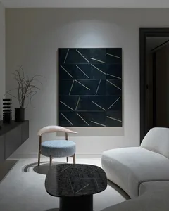 A modern living room featuring a dark bonded leather sofa and a black marble coffee table.