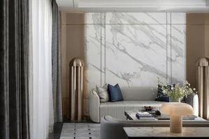 A contemporary living room featuring marble walls and decor.