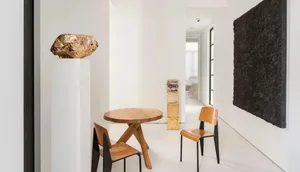 A modern minimalist office space featuring wooden furniture, glass walls, and metal accents.