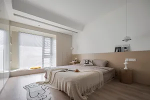 Minimalist bedroom featuring a wooden floor, a bed with a blanket, and a window with shutters.