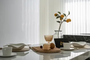 A modern dining room with white ceramic and glass elements.