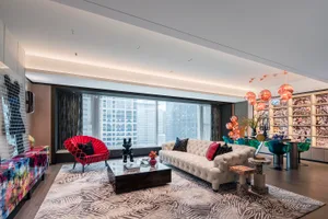 A contemporary living room featuring a mix of materials and stylish furniture.