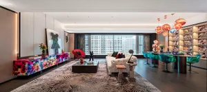 A modern living room featuring colorful furniture, a white sofa, and futuristic lighting.