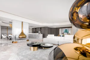 A modern living room featuring marble, black, and gold decor.
