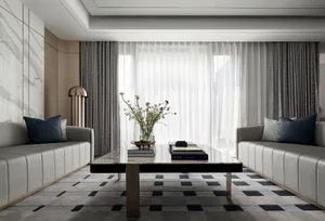 Modern living room featuring marble accents, leather furniture, and glass coffee table.