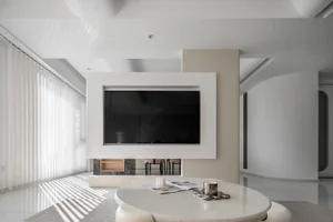 A minimalist living room with a white and black color scheme and concrete elements.