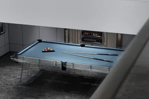 A modern pool table room featuring a glass table with colorful pool balls arranged in a triangle, accompanied by two cues and
