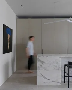 Modern residential kitchen featuring a striking marble countertop and minimalist design.
