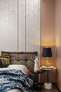 A modern bedroom featuring a bed with a patterned headboard and a textured wallpaper background.