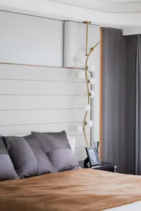 Modern minimalist bedroom with textured white paneled wall