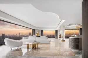 Modern minimalist living room with city view, featuring marble floor, white furniture, and gold accents