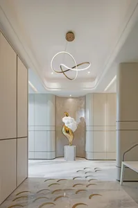 Modern interior design featuring a corridor with marble floor and a gold abstract sculpture.