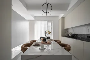 Modern kitchen featuring a marble table with a minimalist design