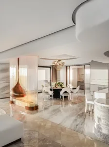 A modern living room featuring marble flooring and a kitchen area with a glass fireplace.