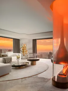 A modern living room featuring a luxurious marble floor and a round coffee table placed on top of the marble floor.