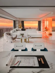 Modern minimalist living room with white marble flooring and furniture.
