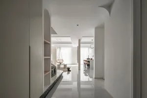 A contemporary living room with white marble flooring, minimalist decor, and a modern lamp.