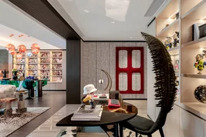 A modern living room featuring black furniture and decorative elements.