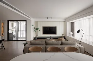 A modern living room with neutral-colored furniture and materials.