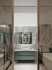 Modern bathroom with marble walls and floor, a green vanity, and a floating sink with a rectangular mirror.