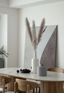 A modern minimalist dining room with wooden furniture and a marble table.