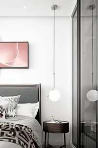 A minimalist bedroom featuring modern lighting and contemporary design elements.