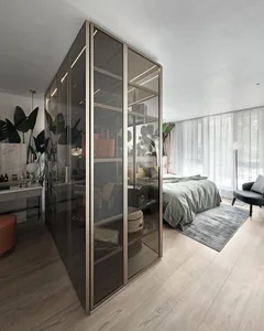 Modern minimalist bedroom featuring a glass wardrobe and upholstered furniture on a wooden floor.