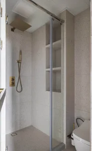 A sleek, modern bathroom with concrete tiles on the floor and walls.