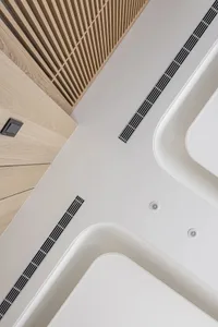 A modern bathroom with white ceramic vessel sinks, minimalist design, and sleek, clean lines.