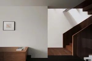 A modern minimalist staircase with black and white color scheme.