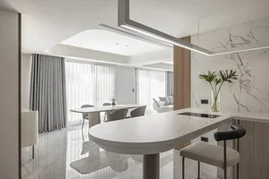 A modern kitchen with marble countertops and wooden accents.