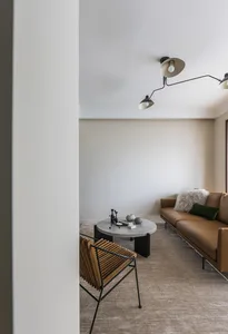 Modern living room featuring a brown leather couch with concrete coffee table.