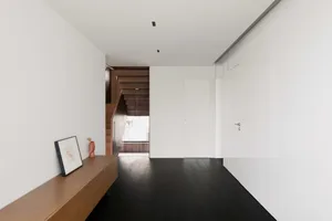 Modern minimalist interior design with minimalist furniture, wooden floors, and glass elements.