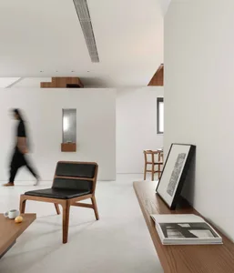 A modern minimalist living room featuring wooden furniture
