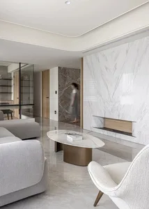 Modern minimalist living room with marble floor and furniture, featuring a sleek marble coffee table.