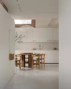 Modern residential kitchen featuring concrete floor and wood accents