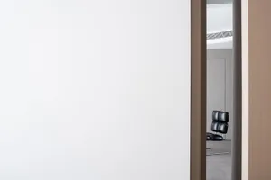 Modern minimalist bedroom with white walls and furniture