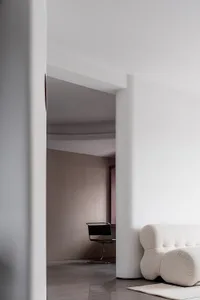 A minimalist interior design featuring concrete materials and modern furniture