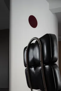 A black leather industrial-style chair with a unique design.