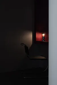A minimalist office space featuring an industrial design aesthetic with metal fixtures.