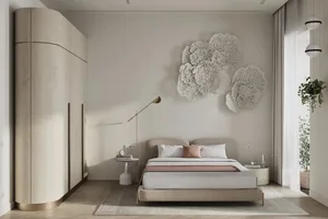 A bedroom with a neutral color palette featuring a bed, nightstand, and decorative wall art.
