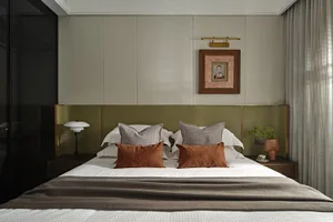 Contemporary bedroom with modern furniture, featuring fabric upholstery and minimalist design.