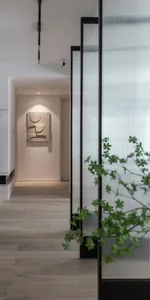 A modern entryway featuring a glass panel, minimalist design, and a soft, ambient light. Includes a sleek floor plan and cont