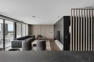 Modern living room featuring a sleek, minimalist design with concrete walls and flooring.
