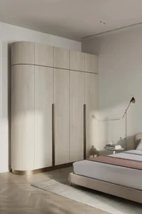 Modern minimalist bedroom with wooden cabinets and a beige upholstered bed.