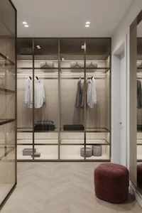 A modern minimalist closet with a glass frame, showcasing organized clothing storage.