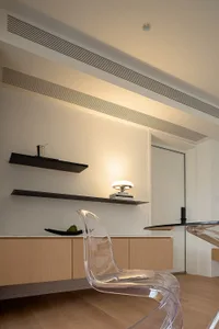 Modern, minimalist living room featuring glass and wood elements.