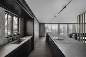 Modern kitchen with granite countertops and minimalist design