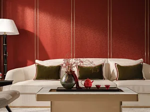 A stylish modern living room featuring a white sofa adorned with plush cushions and a coffee table displaying decorative item